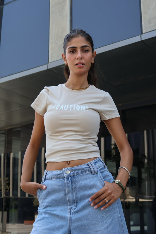 ⁠⁠Printed beige caution top